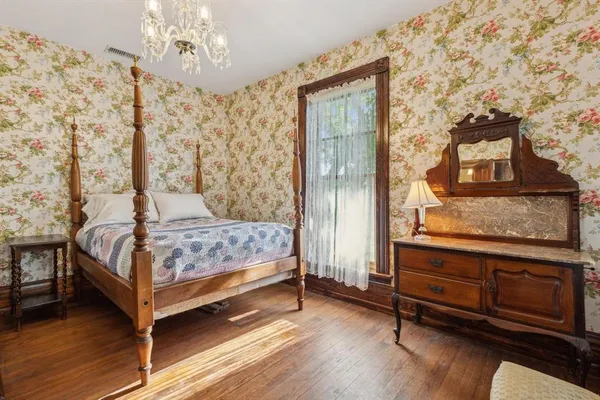 a bedroom with a bed and a mirror