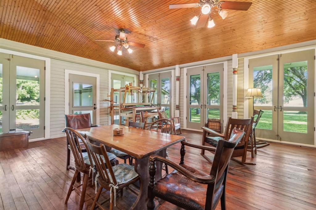 405 West Clifton Street Pilot Point, TX 76258 - Photo 19 of 33 a view of a dining room with furniture window and wooden floor
