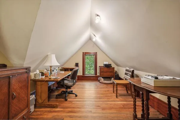 a living room with furniture a rug potted plant and a large window