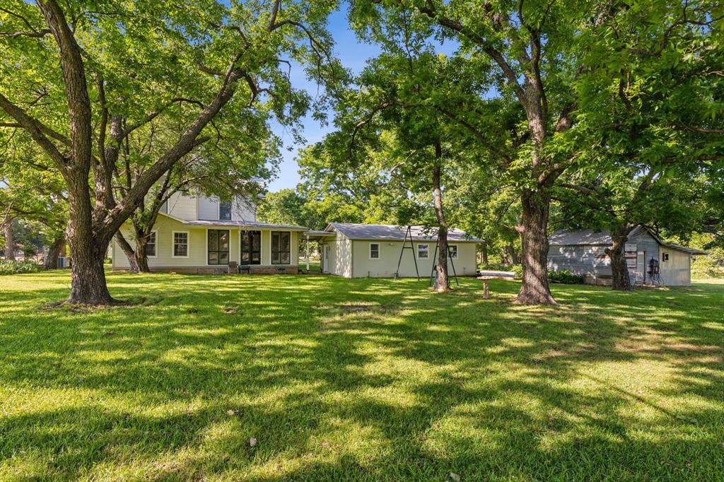 405 West Clifton Street Pilot Point, TX 76258 - Photo 22 of 33 a front view of a house with a garden
