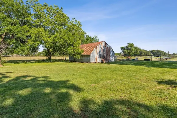 a view of yard with swimming pool and green space