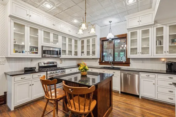 a kitchen with a table chairs stove and cabinets
