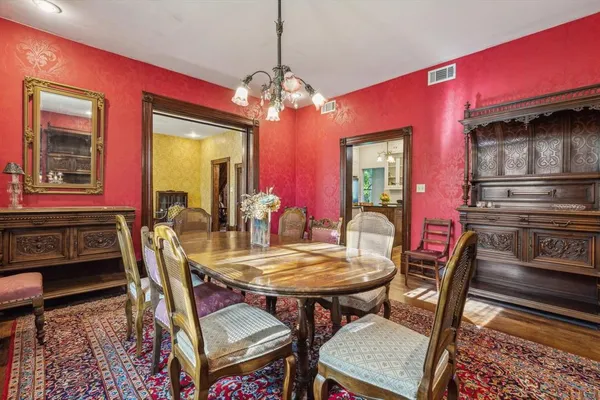 a view of a dining room with furniture and chandelier