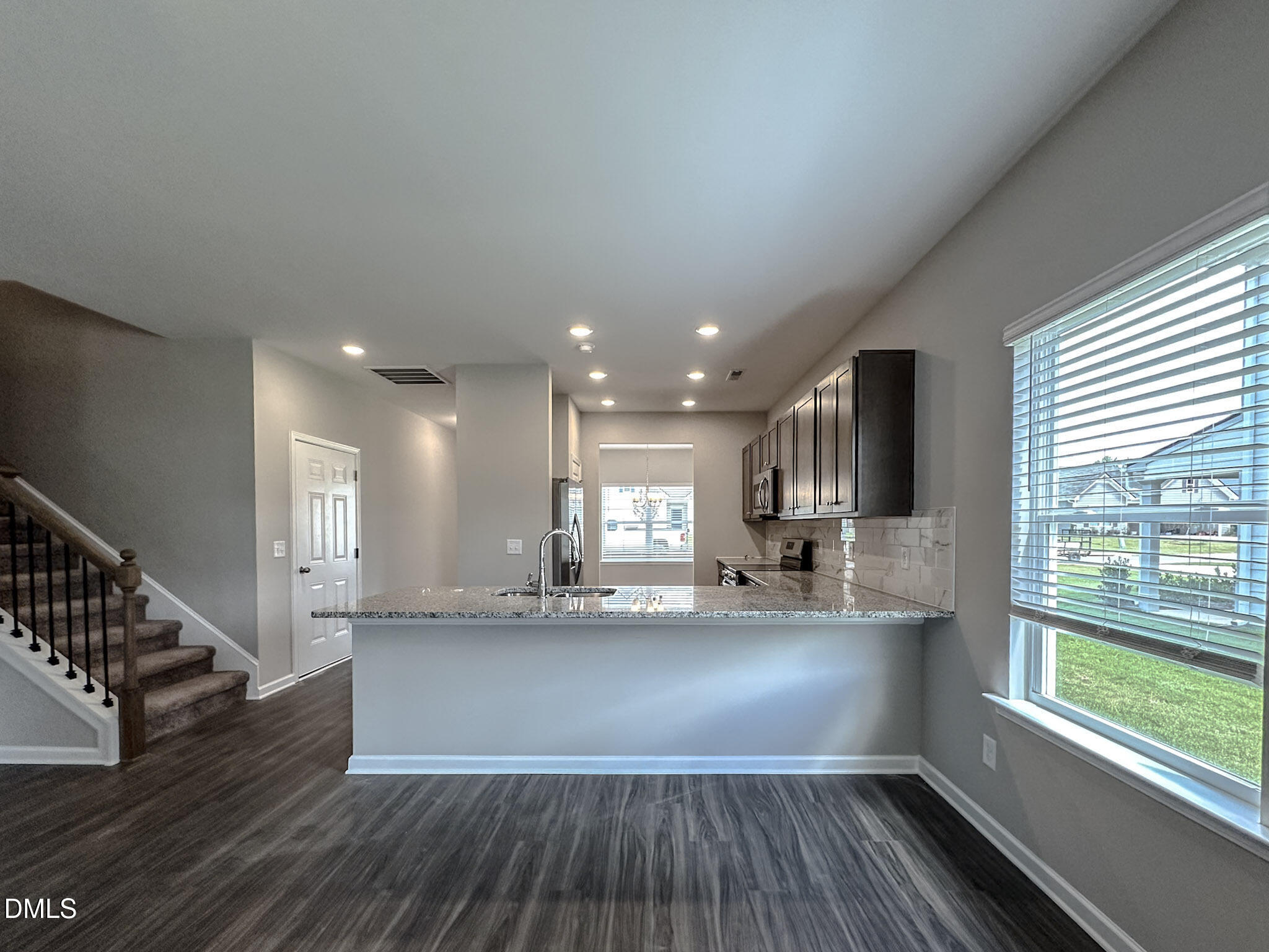 349 Spirit Spgs Road Smithfield, NC 27577 - Photo 8 of 23 a large kitchen with stainless steel appliances a large window a sink and a counter top space