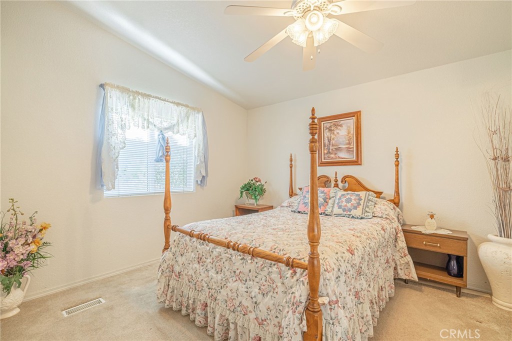 29520 Piani Road Pearblossom, CA 93553 - Photo 26 of 40 a bedroom with a bed and a chandelier