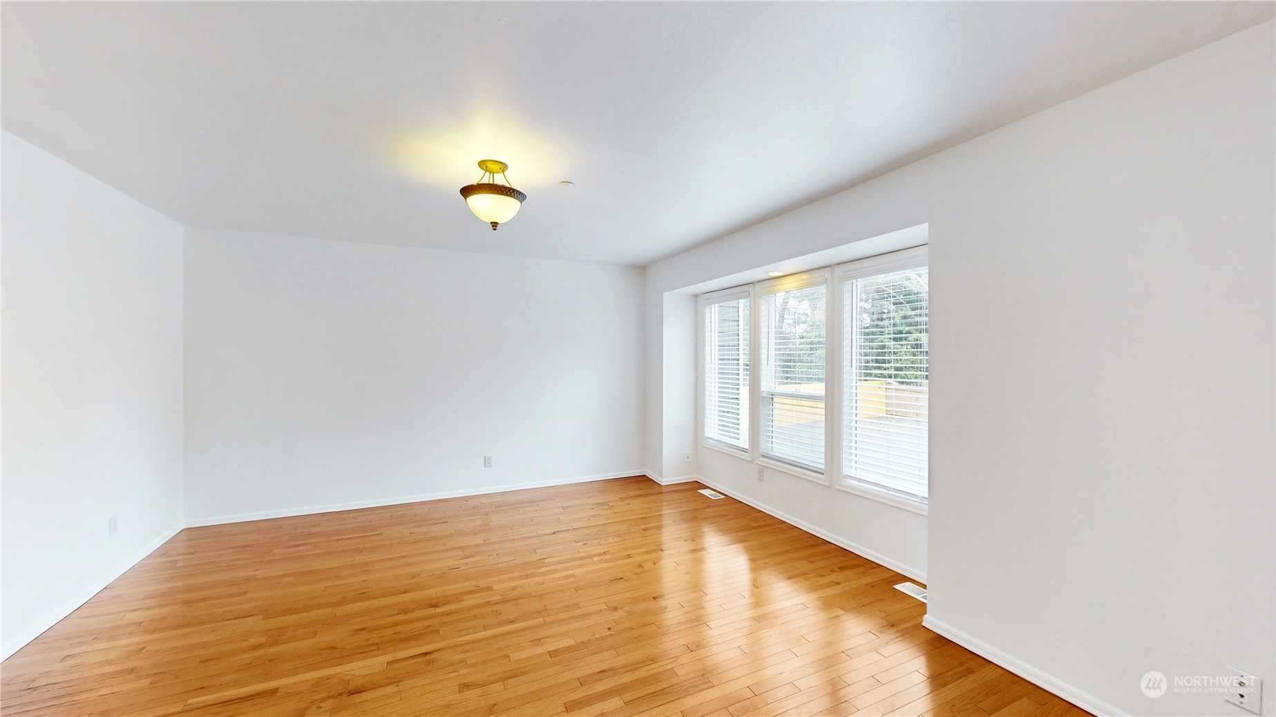 6426 Cady Road Everett, WA 98203 - Photo 29 of 39 a view of an empty room with wooden floor and a window
