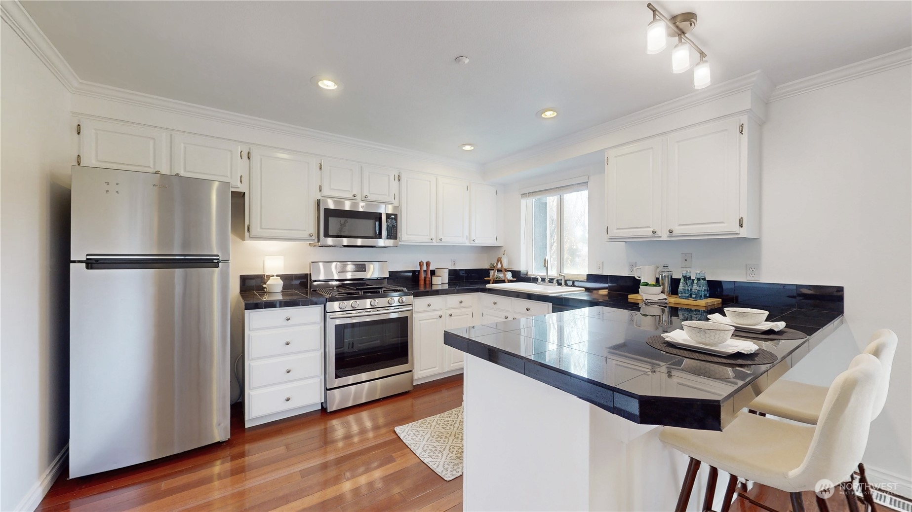 6426 Cady Road Everett, WA 98203 - Photo 6 of 39 a kitchen with refrigerator cabinets and wooden floor