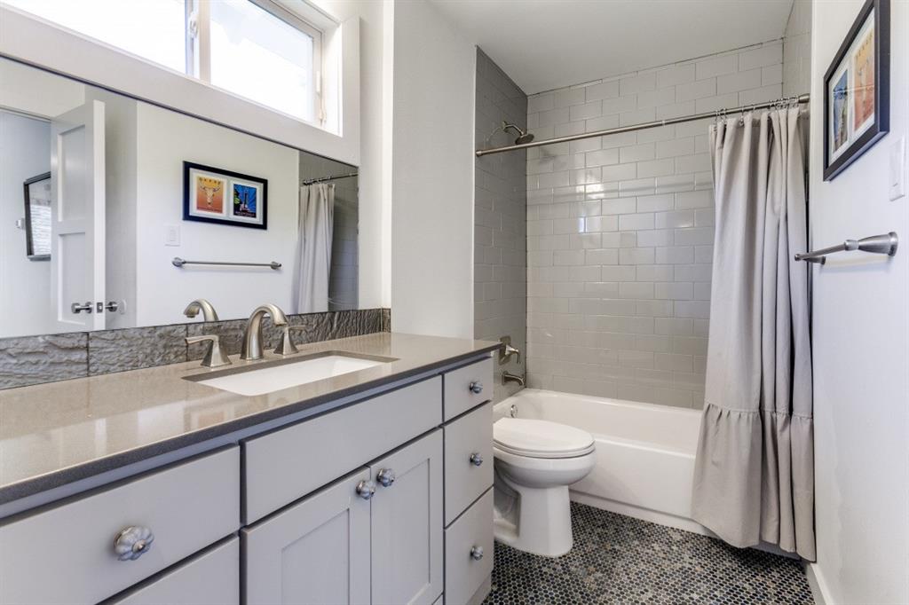 4206 Manning Lane Dallas, TX 75220 - Photo 25 of 35 a bathroom with a granite countertop sink toilet and shower