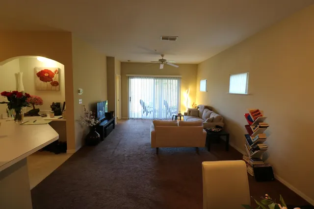 a living room with furniture and a large window