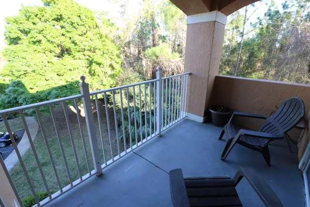 a view of a chair and table in the balcony
