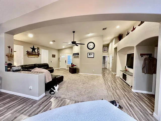 a kitchen with stainless steel appliances kitchen island granite countertop a stove and a sink
