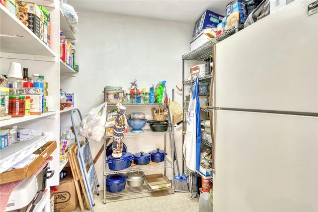 a backyard of a house with large trees and wooden fence