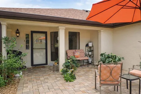 a front view of a house with potted plants