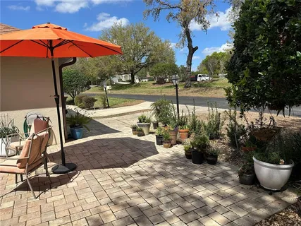 a view of a backyard with sitting area