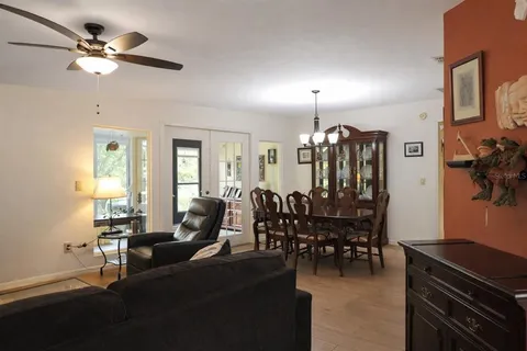 a living room with lots of furniture and chandelier