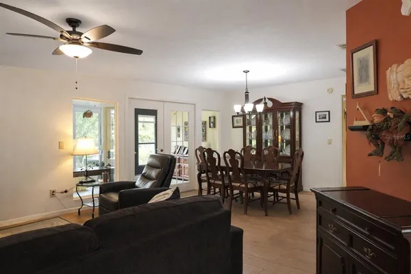 a living room with lots of furniture and chandelier