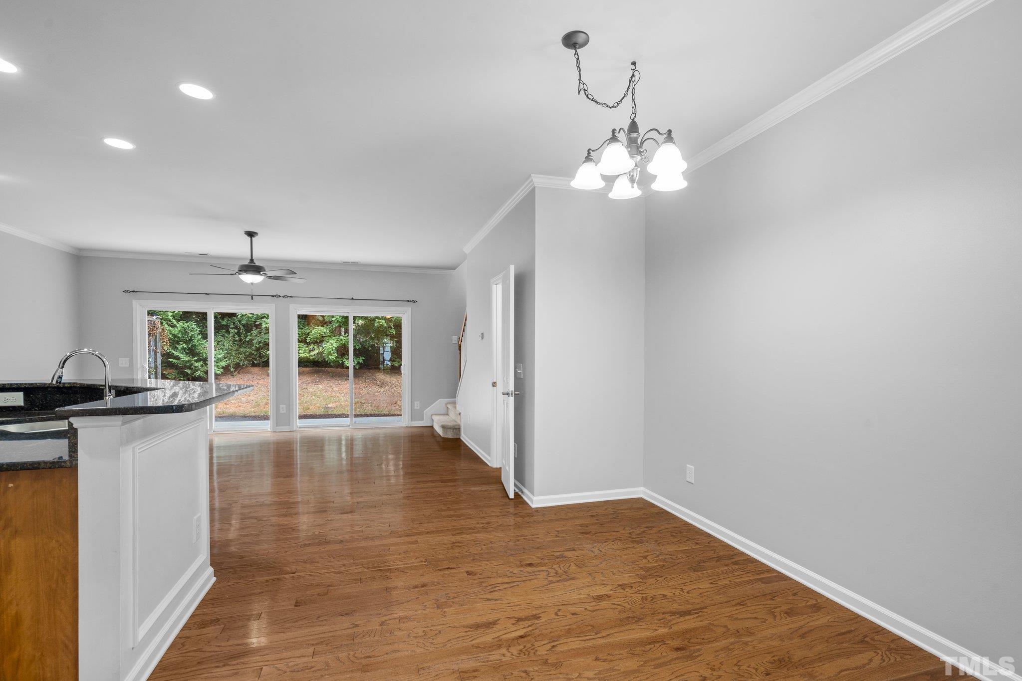8308 Pilots View Drive Raleigh, NC 27617 - Photo 12 of 29 a view of a kitchen with a stove wooden floor and a chandelier