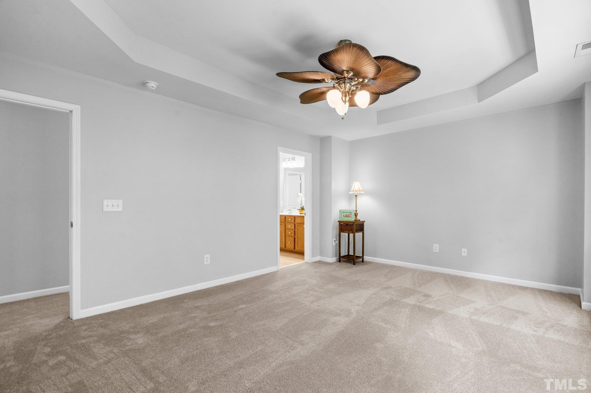 8308 Pilots View Drive Raleigh, NC 27617 - Photo 16 of 29 a view of an empty room with a chandelier fan