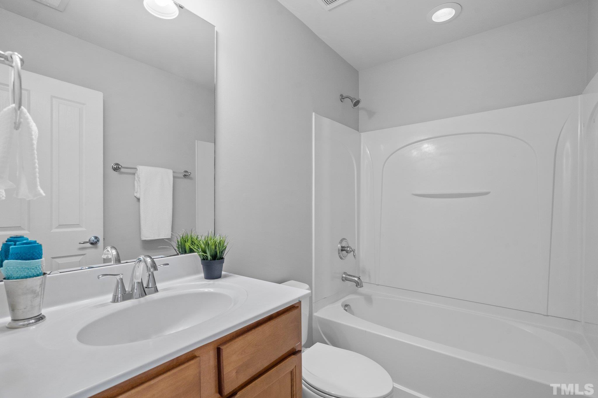 8308 Pilots View Drive Raleigh, NC 27617 - Photo 23 of 29 a bathroom with a granite countertop sink toilet and shower