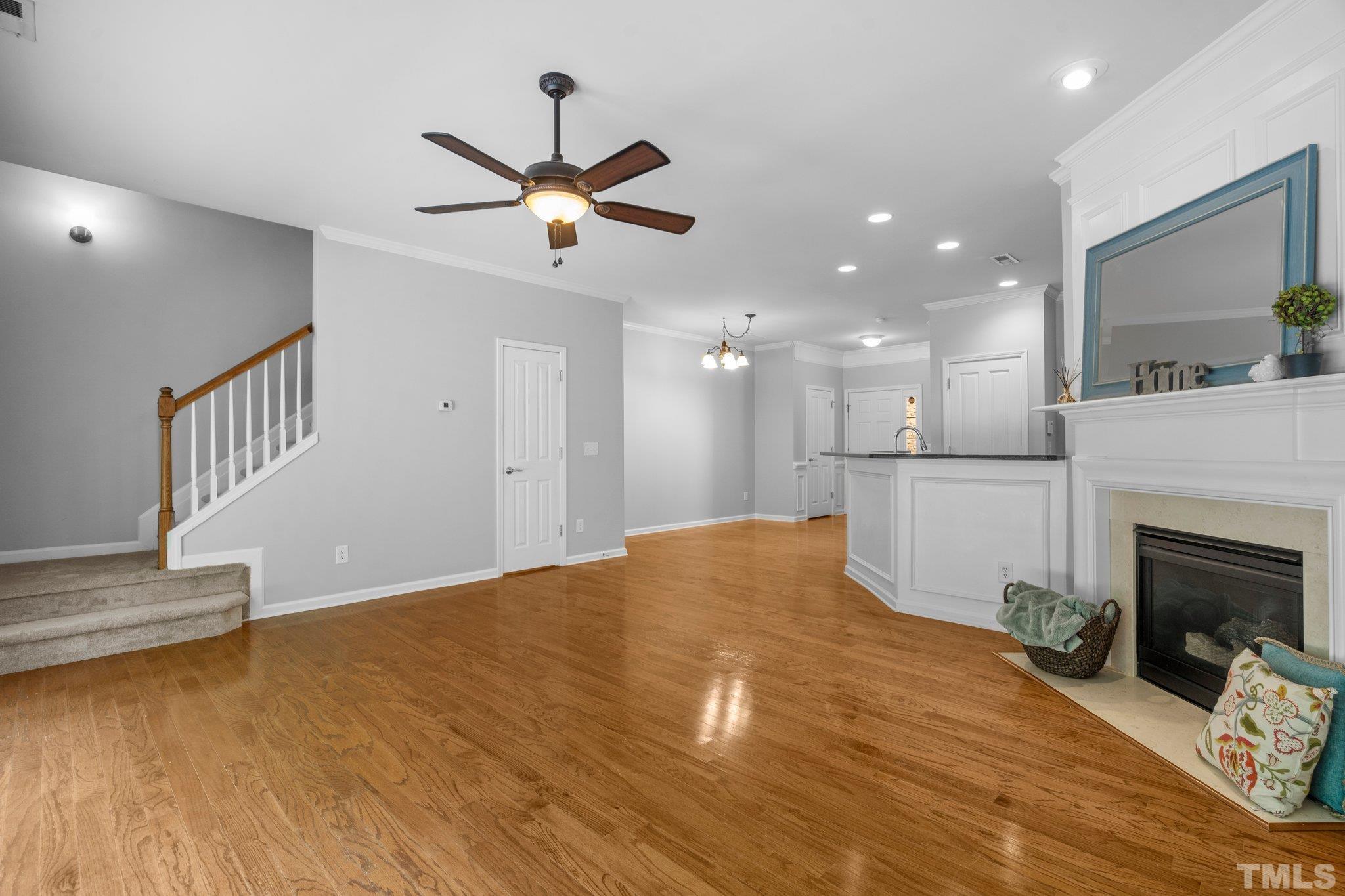 8308 Pilots View Drive Raleigh, NC 27617 - Photo 5 of 29 a view of a livingroom with a kitchen and a fireplace