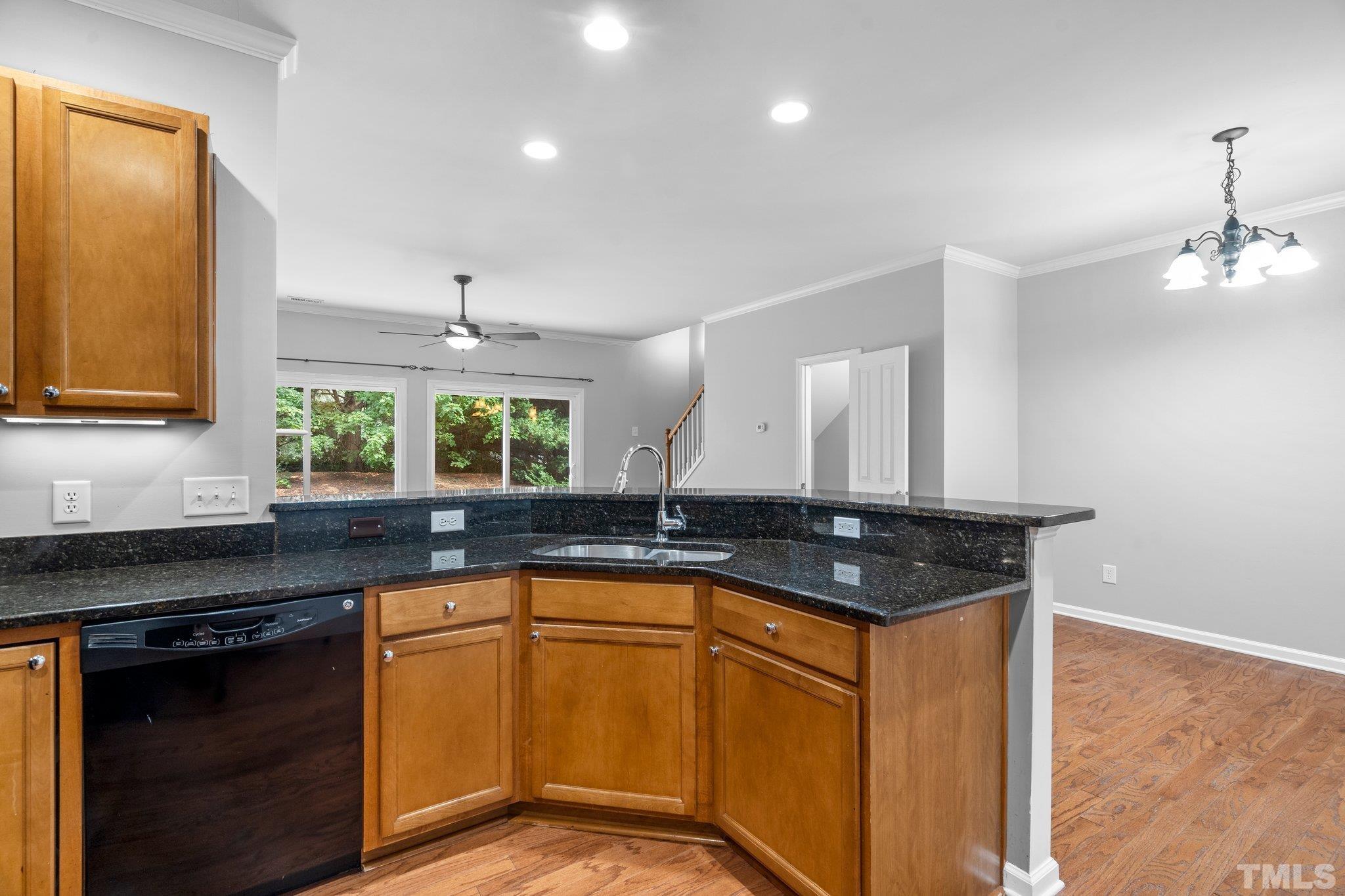 8308 Pilots View Drive Raleigh, NC 27617 - Photo 6 of 29 a kitchen with granite countertop a sink and a stove