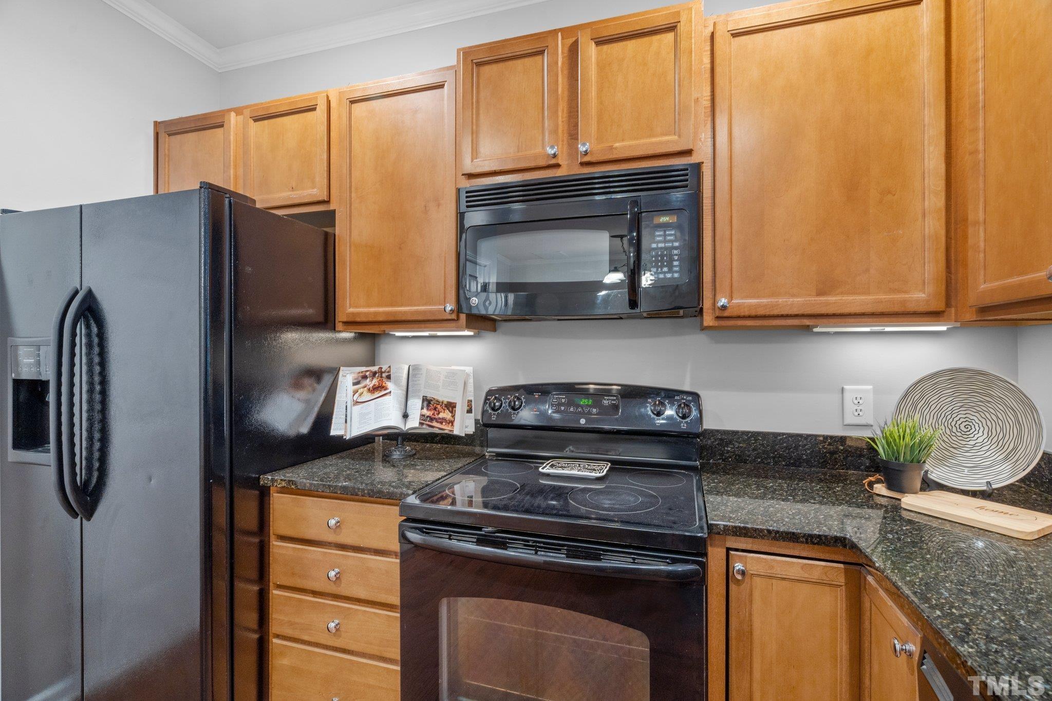 8308 Pilots View Drive Raleigh, NC 27617 - Photo 8 of 29 a kitchen with stainless steel appliances granite countertop a refrigerator stove and sink