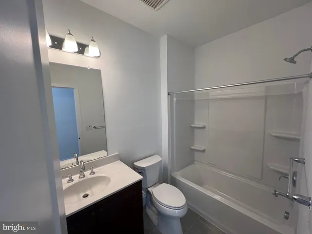 an empty room with wooden floor and closet