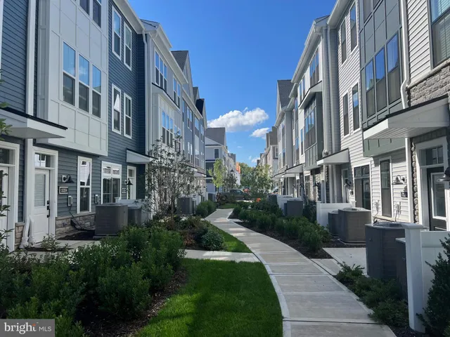 a city street lined with tall buildings and a yard