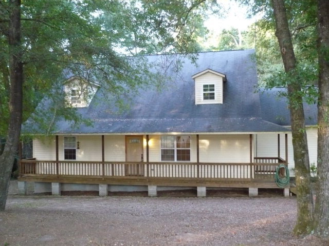 1086 Country Club Road Fort Valley, GA 31030 - Photo 1 of 7 a view of a brick house with a large window and a table