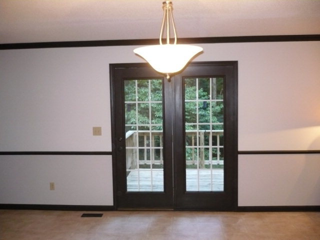 1086 Country Club Road Fort Valley, GA 31030 - Photo 4 of 7 a view of a room with large windows and wooden floor