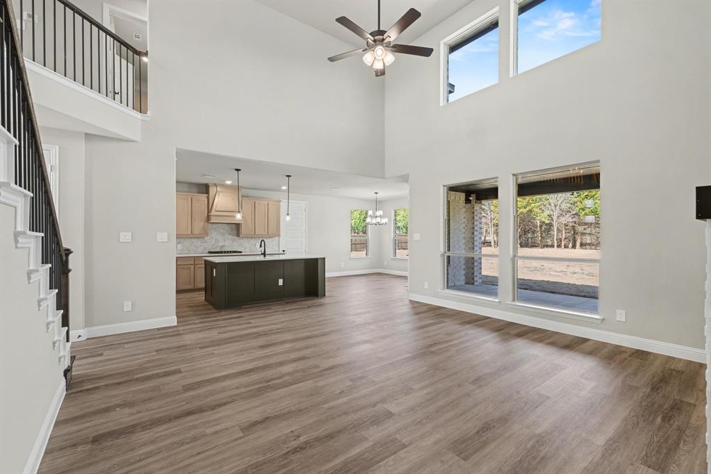 7041 Champion Road Midlothian, TX 76065 - Photo 6 of 30 a view of a kitchen with a sink a ceiling fan and wooden floor