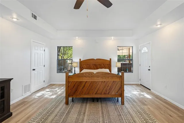 a bedroom with a bed and wooden floor