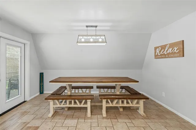 a view of a room with chairs and window