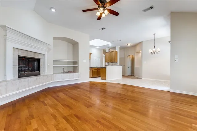 wooden floor in an empty room with a fireplace