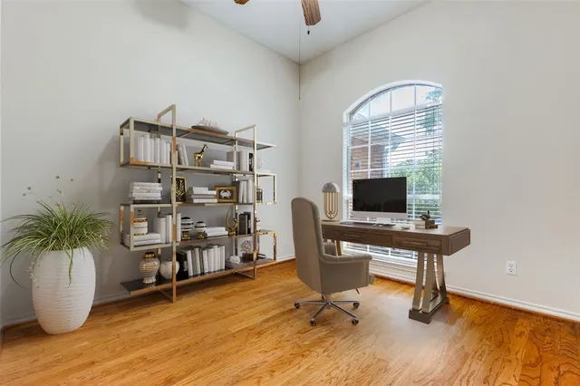 a view of a workspace with furniture and a window