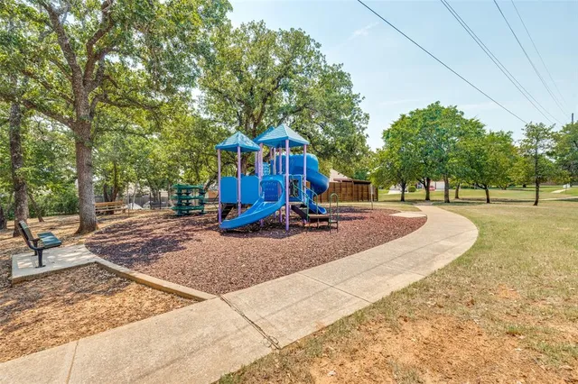 a view of outdoor space with playground and green space