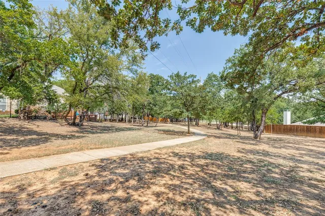 a view of a yard with large trees