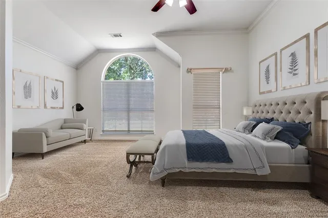 a spacious bedroom with a bed and a large window