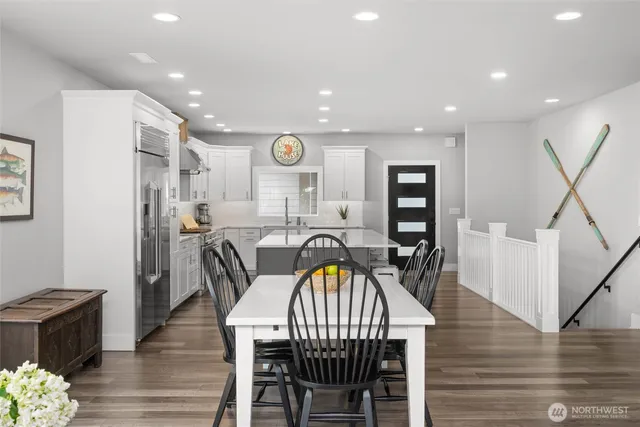 a view of a a dining room with furniture window and wooden floor