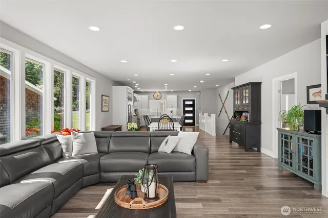 a living room with furniture and a wooden floor