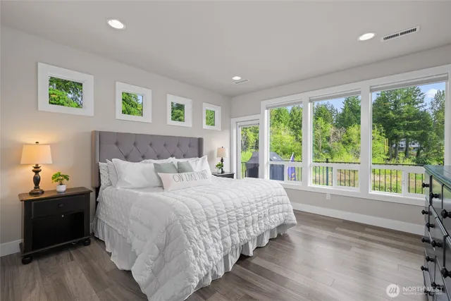 a bedroom with a bed and a large window
