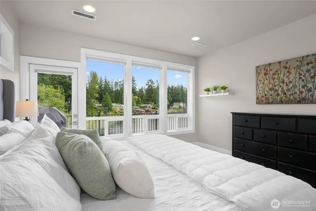 a bedroom with a bed and a large window