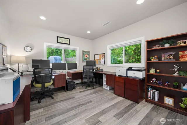 a room with furniture a bookshelf and a window