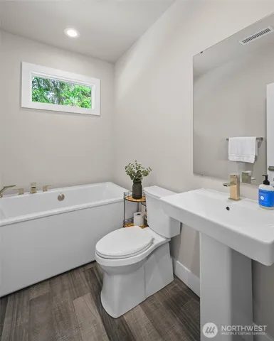 a bathroom with a sink a toilet and a bathtub