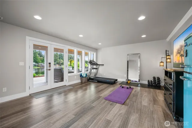 a view of a room with gym equipment and large windows