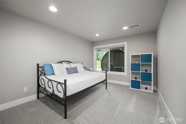 a bed room with a bed and a large window