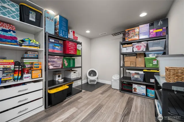 a living room with furniture a flat screen tv and a book shelf