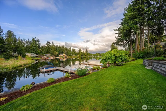 a view of a lake with houses in the back
