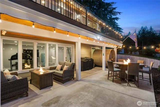 a view of a patio with dining table and chairs with wooden floor and fence