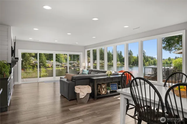 a living room with furniture and a floor to ceiling window